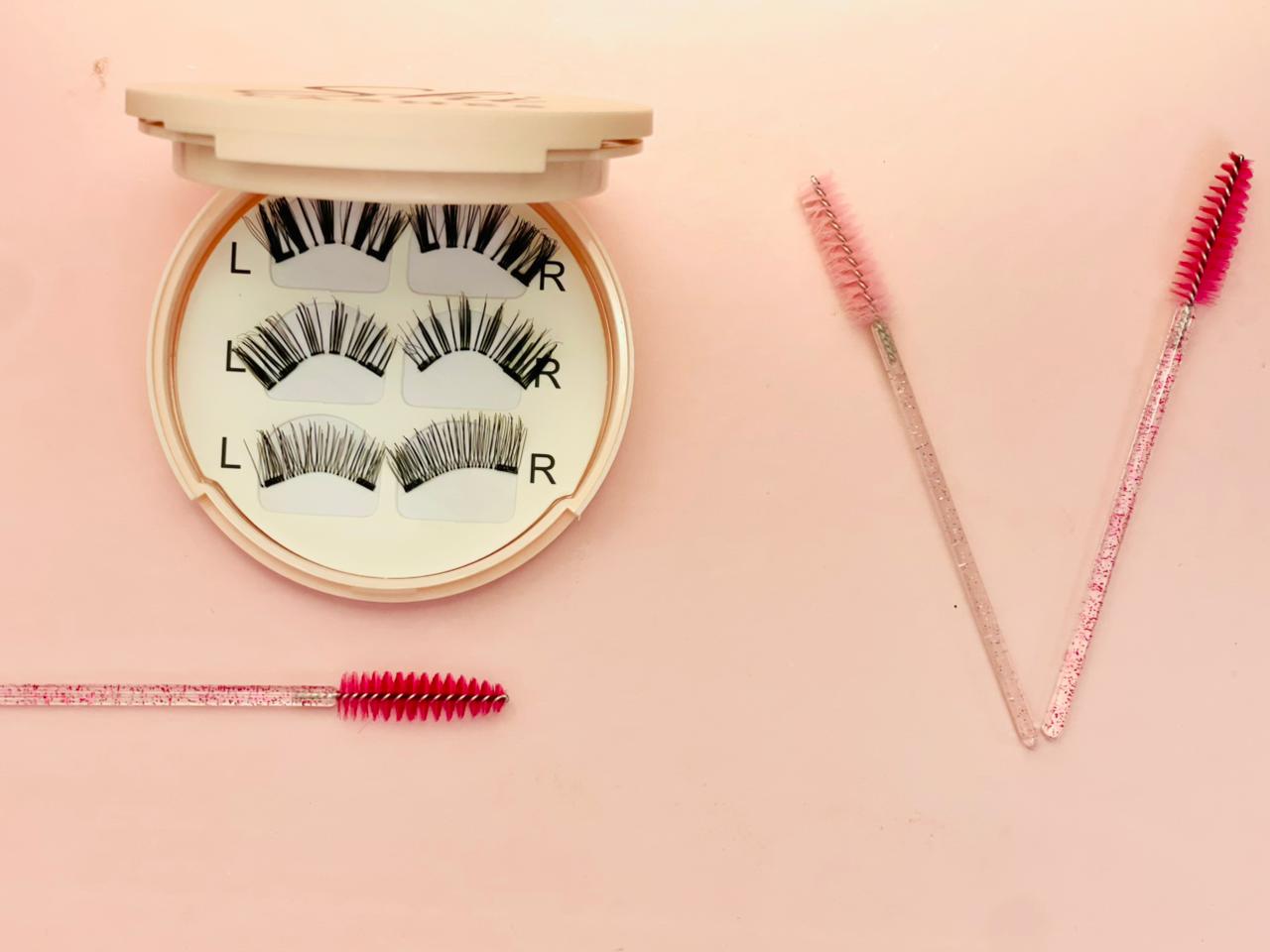 Shi Lashes magnetic kit with lashes and pink spoolie brushes on soft pink background